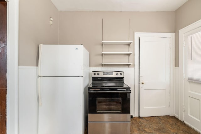 kitchen with stainless steel electric range, open shelves, and freestanding refrigerator