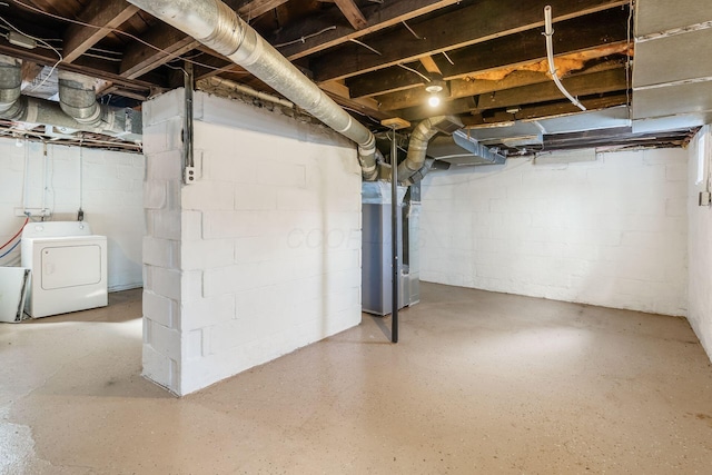 unfinished basement with washer / clothes dryer and heating unit