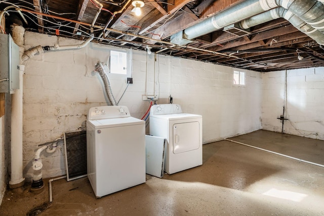 below grade area with a healthy amount of sunlight and washing machine and clothes dryer