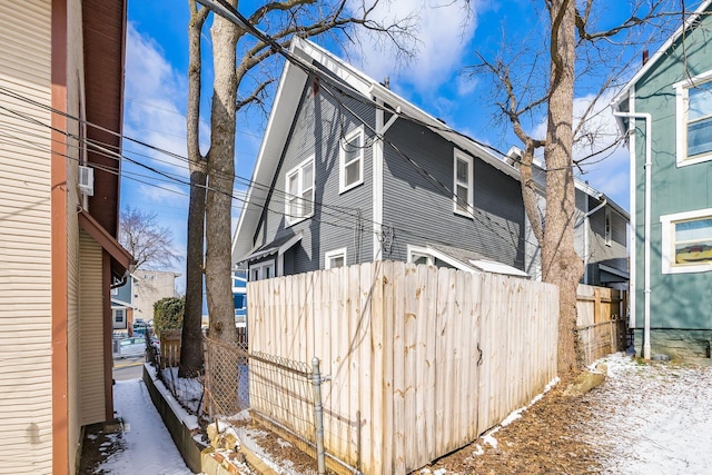 snow covered property with fence