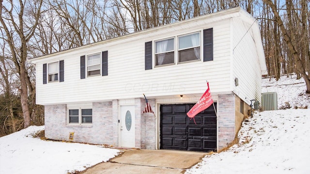 view of front facade with a garage and brick siding