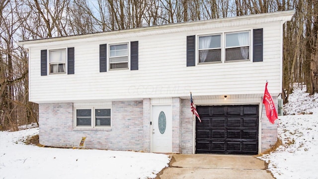 view of front facade featuring a garage and brick siding