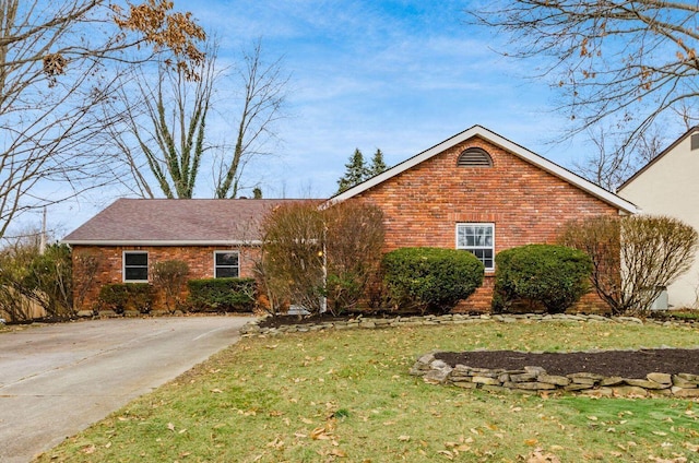 single story home with a front yard and brick siding