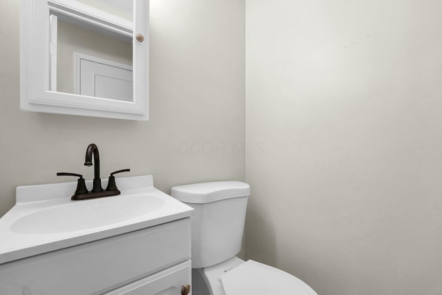 bathroom with toilet and vanity