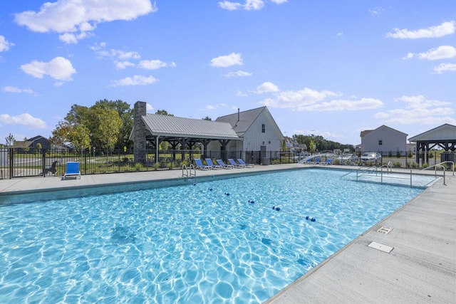 pool with a patio area and fence