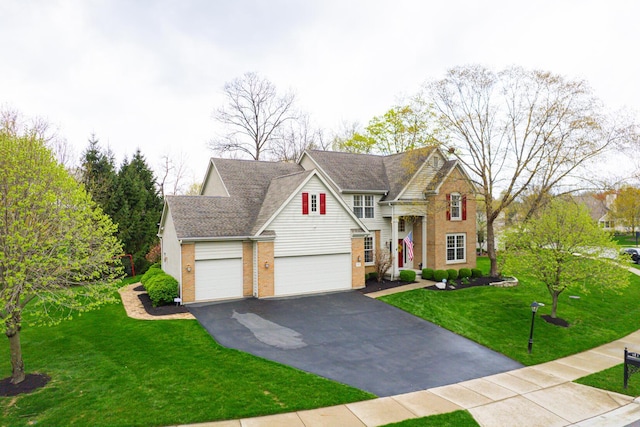 413 Ashmoore Cir E, Powell, OH 43065 - view of front of home with a front lawn, aphalt driveway, and brick siding