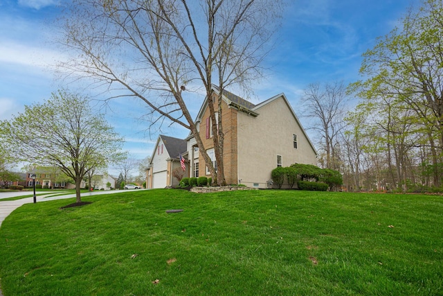 413 Ashmoore Cir E, Powell, OH 43065 - view of side of home with an attached garage, a lawn, and stucco siding