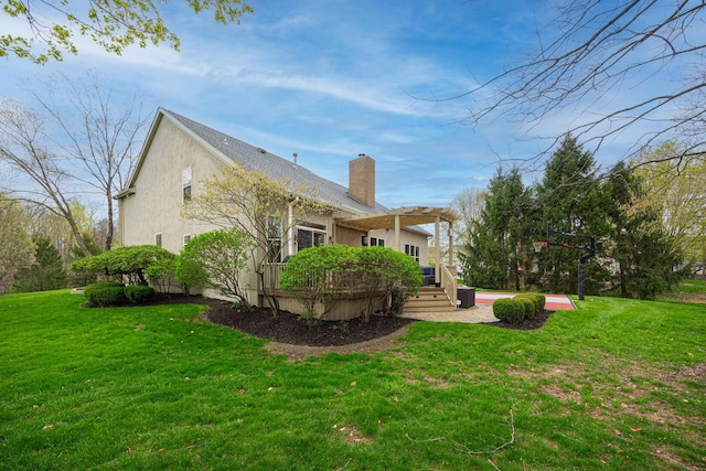 413 Ashmoore Cir E, Powell, OH 43065 - exterior space with a lawn, a chimney, a deck, and stucco siding