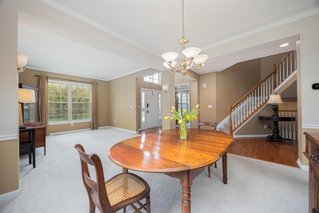 413 Ashmoore Cir E, Powell, OH 43065 - carpeted dining area featuring ornamental molding, stairway, a chandelier, and baseboards
