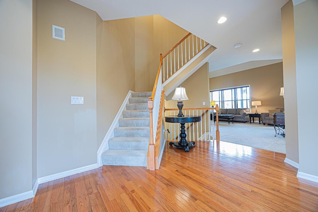 413 Ashmoore Cir E, Powell, OH 43065 - staircase featuring wood finished floors, recessed lighting, and baseboards