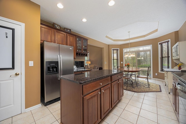 413 Ashmoore Cir E, Powell, OH 43065 - kitchen featuring a chandelier, light tile patterned floors, stainless steel appliances, and baseboards