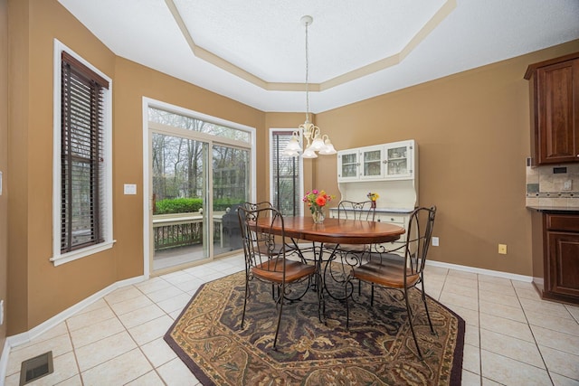 413 Ashmoore Cir E, Powell, OH 43065 - dining room with light tile patterned floors, visible vents, a notable chandelier, and baseboards
