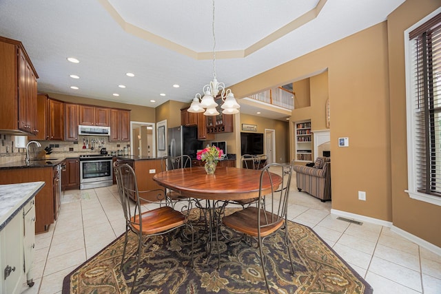 413 Ashmoore Cir E, Powell, OH 43065 - dining room featuring recessed lighting, an inviting chandelier, light tile patterned floors, visible vents, and baseboards