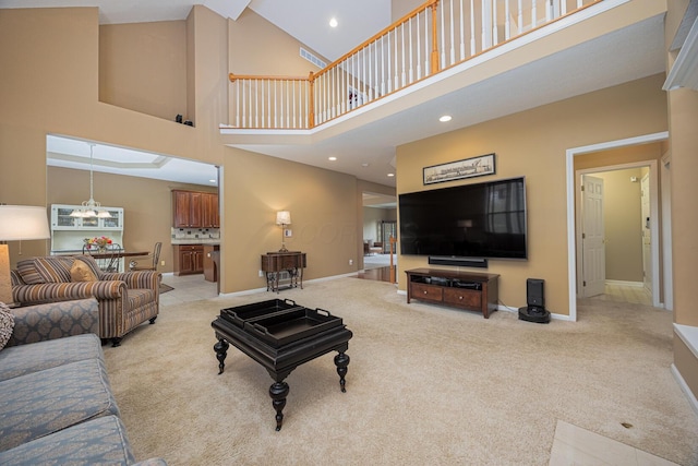 413 Ashmoore Cir E, Powell, OH 43065 - living area with baseboards, light carpet, and a towering ceiling