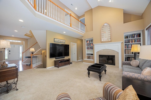 413 Ashmoore Cir E, Powell, OH 43065 - living room with carpet flooring, stairs, recessed lighting, high vaulted ceiling, and built in shelves