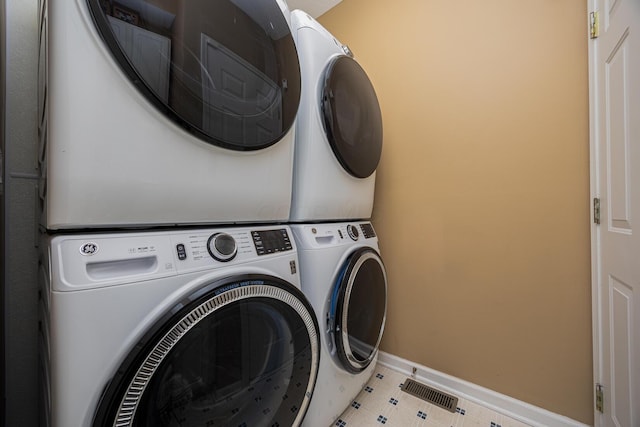 413 Ashmoore Cir E, Powell, OH 43065 - laundry area featuring baseboards, visible vents, stacked washer and dryer, and laundry area