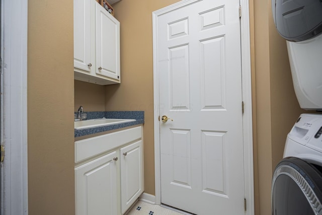 413 Ashmoore Cir E, Powell, OH 43065 - washroom featuring stacked washer / drying machine, cabinet space, and a sink