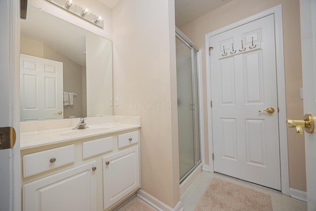 413 Ashmoore Cir E, Powell, OH 43065 - full bath with baseboards, tile patterned floors, a shower stall, and vanity
