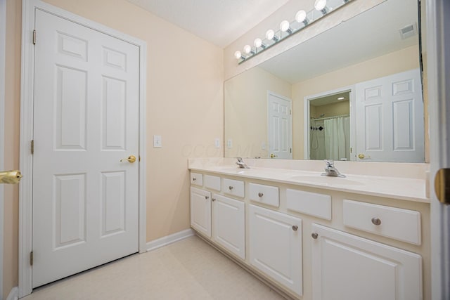 413 Ashmoore Cir E, Powell, OH 43065 - bathroom with a shower with curtain, a sink, double vanity, visible vents, and baseboards