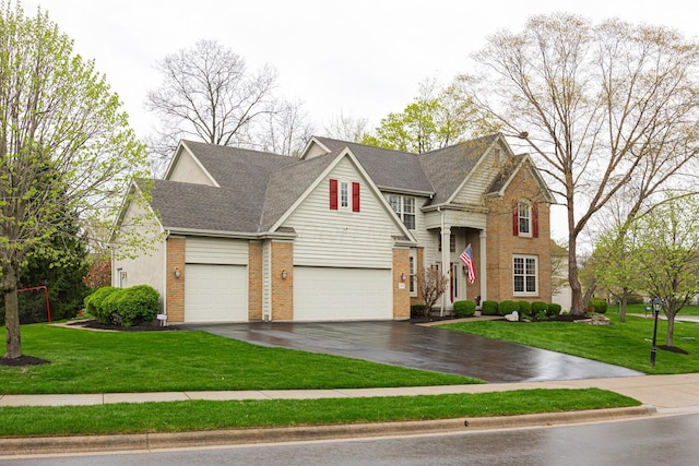413 Ashmoore Cir E, Powell, OH 43065 - traditional-style house featuring a garage, brick siding, aphalt driveway, and a front lawn