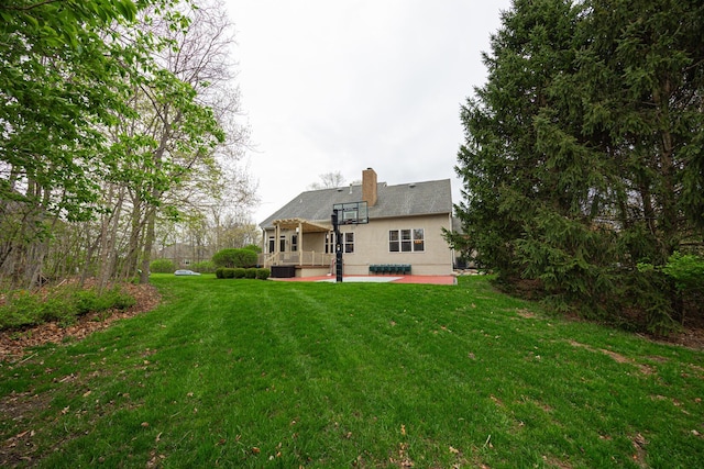 413 Ashmoore Cir E, Powell, OH 43065 - rear view of house featuring a lawn, a chimney, central AC, and a patio area