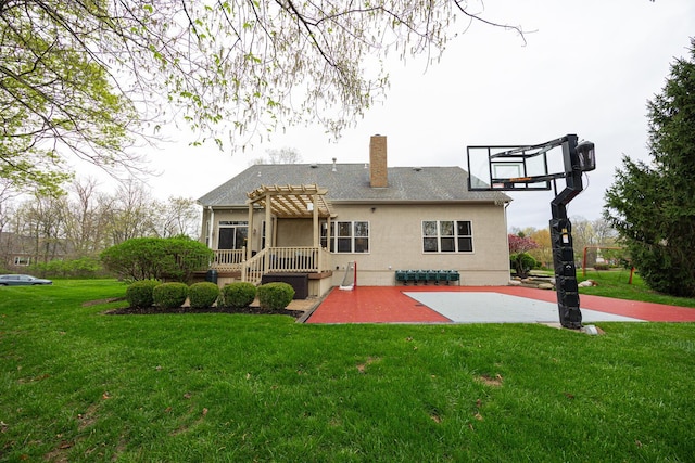 413 Ashmoore Cir E, Powell, OH 43065 - back of property featuring a pergola, a patio area, a lawn, a chimney, and stucco siding