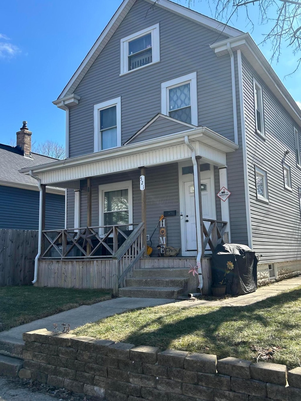 traditional style home with fence and a porch