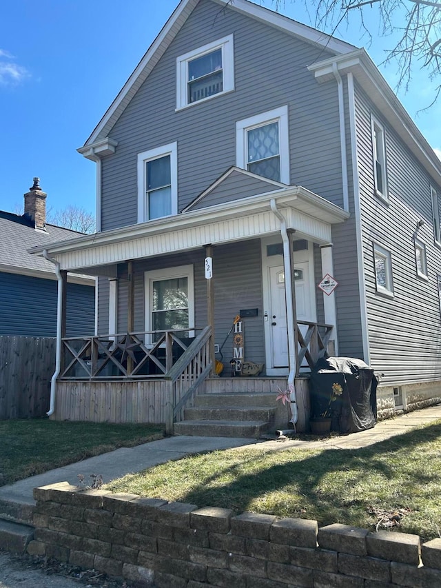 traditional style home with fence and a porch