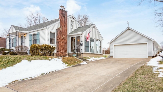 view of front of home with a garage, a shingled roof, and a chimney