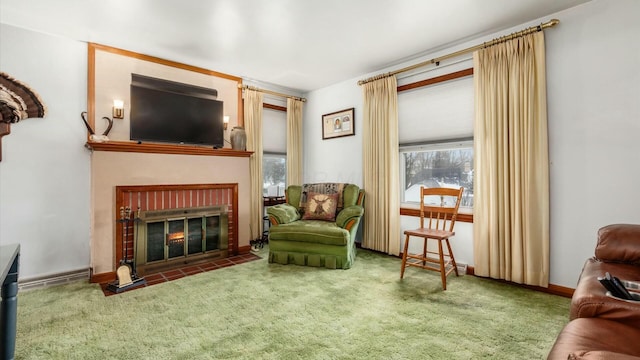 living area featuring carpet floors, a brick fireplace, and baseboards