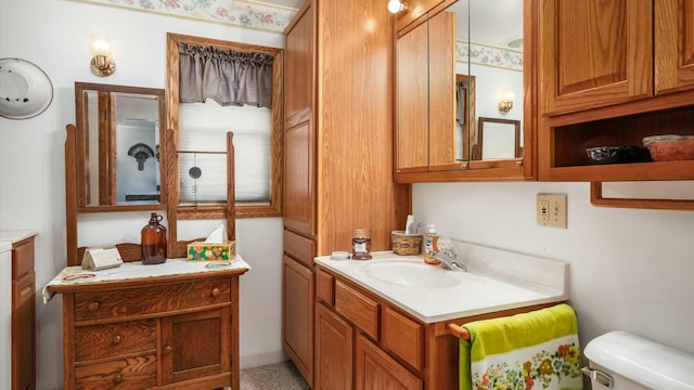 bathroom featuring toilet and vanity