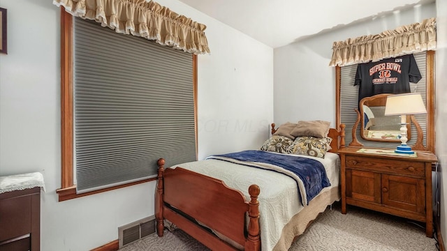 bedroom with light carpet and visible vents