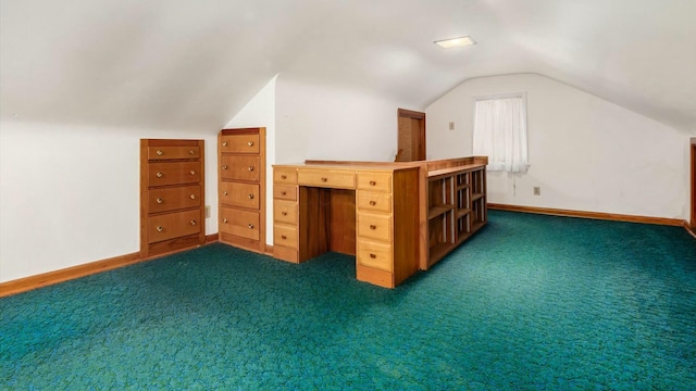 additional living space featuring lofted ceiling, baseboards, and dark carpet