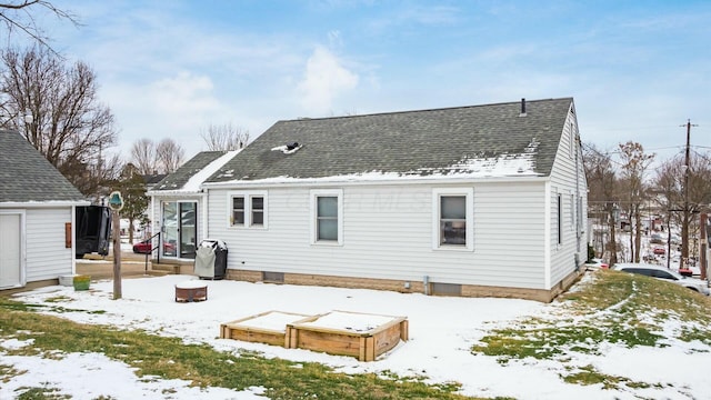 snow covered house with a shingled roof