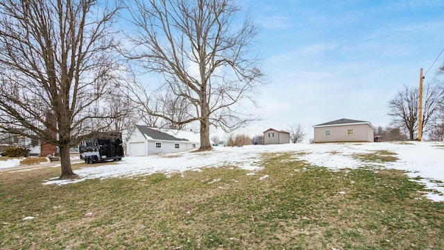 yard layered in snow featuring a garage