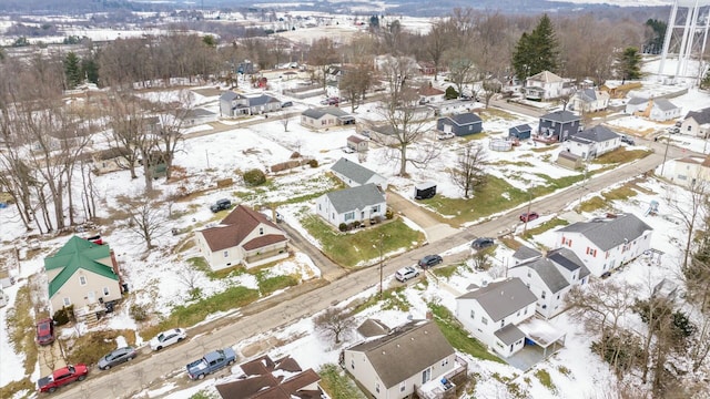 snowy aerial view featuring a residential view