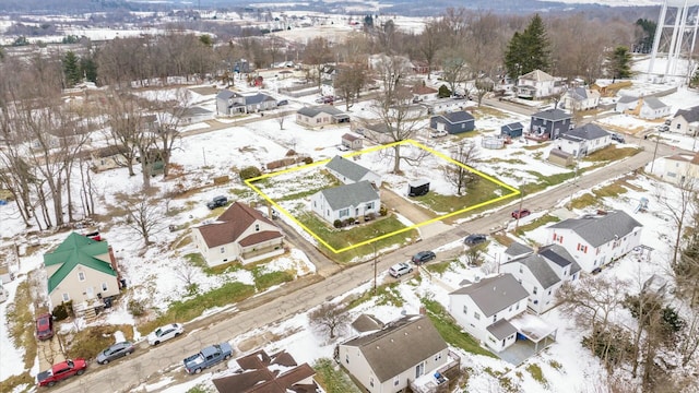 snowy aerial view featuring a residential view