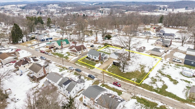 snowy aerial view featuring a residential view