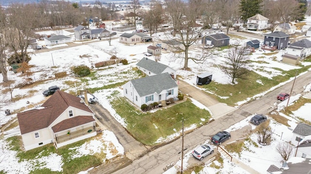 snowy aerial view with a residential view