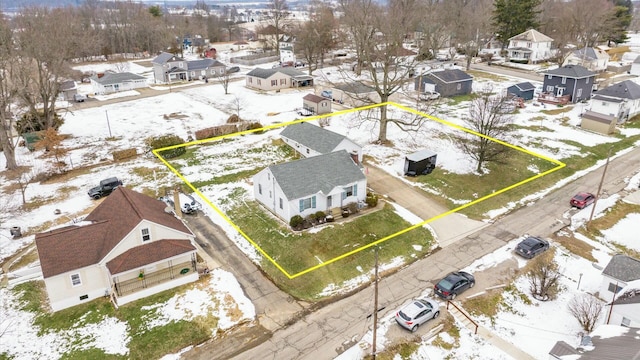 snowy aerial view with a residential view