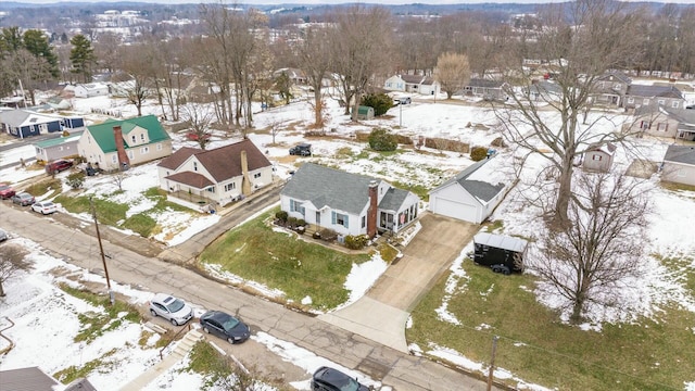 snowy aerial view with a residential view