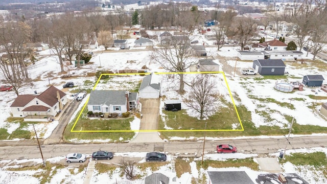 snowy aerial view featuring a residential view