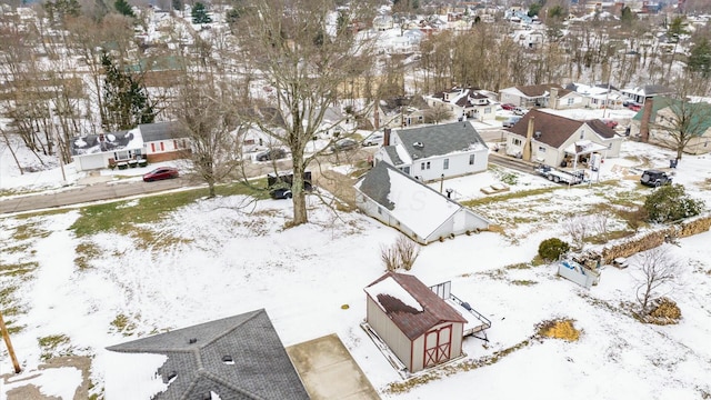 snowy aerial view featuring a residential view