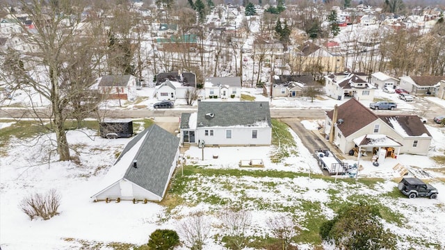 snowy aerial view featuring a residential view