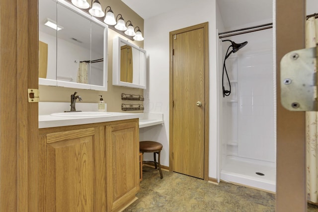 bathroom with visible vents, a shower stall, and vanity