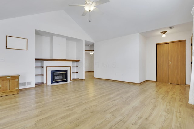 unfurnished living room featuring light wood finished floors, visible vents, a ceiling fan, a tile fireplace, and baseboards