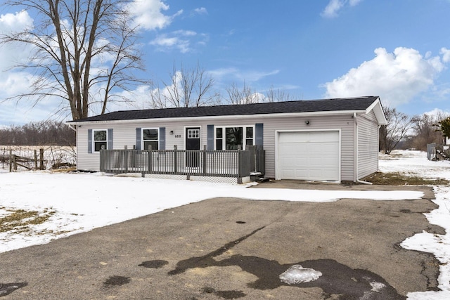 ranch-style house with an attached garage and a deck