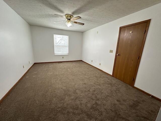 unfurnished room featuring a textured ceiling, ceiling fan, carpet, and baseboards