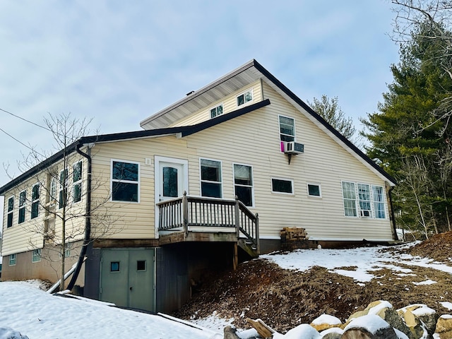 snow covered house featuring cooling unit