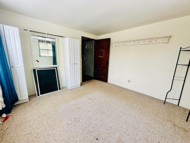 unfurnished bedroom with light colored carpet